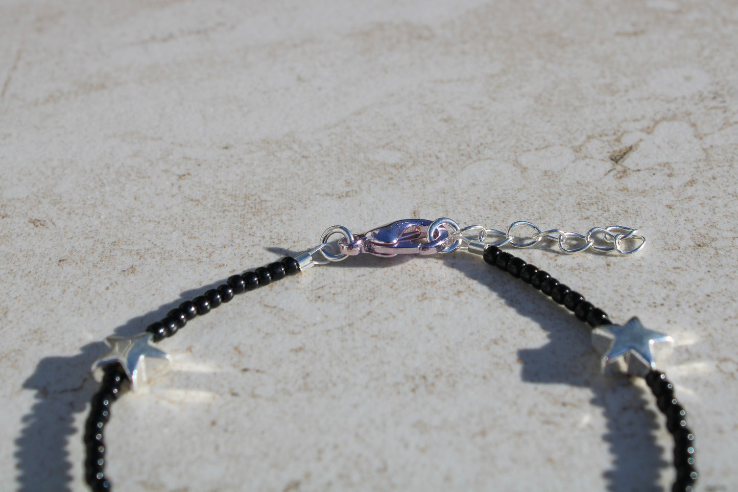 Black Beaded Bracelet with Silver Star Charms