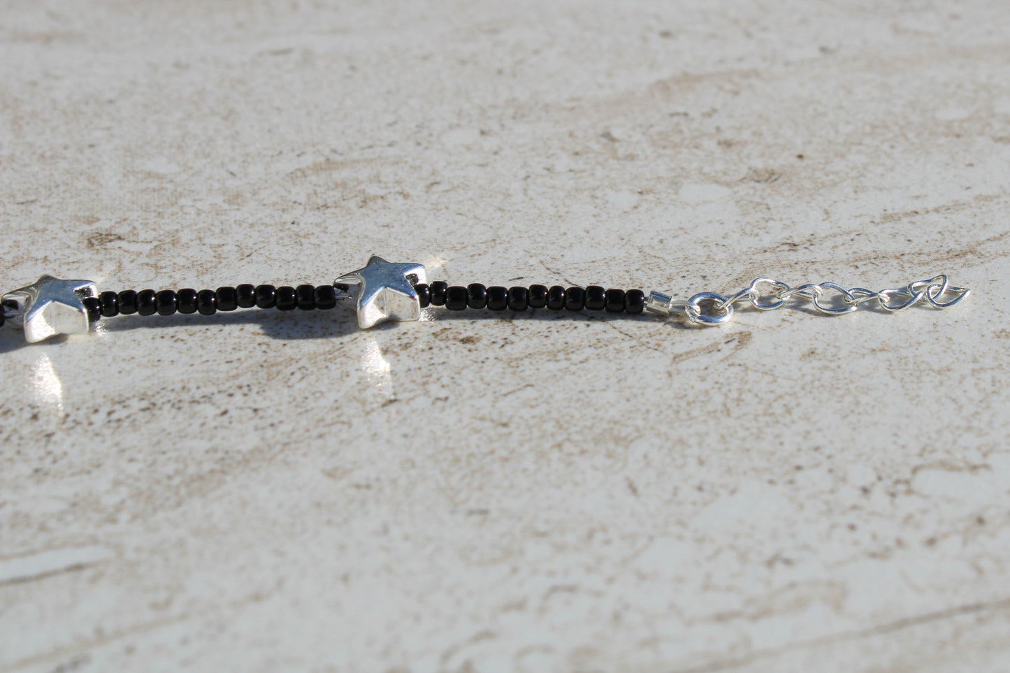 Black Beaded Bracelet with Silver Star Charms