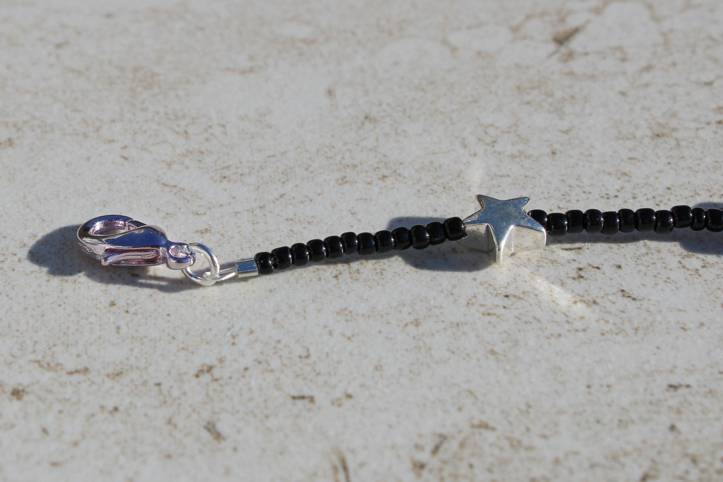 Black Beaded Bracelet with Silver Star Charms