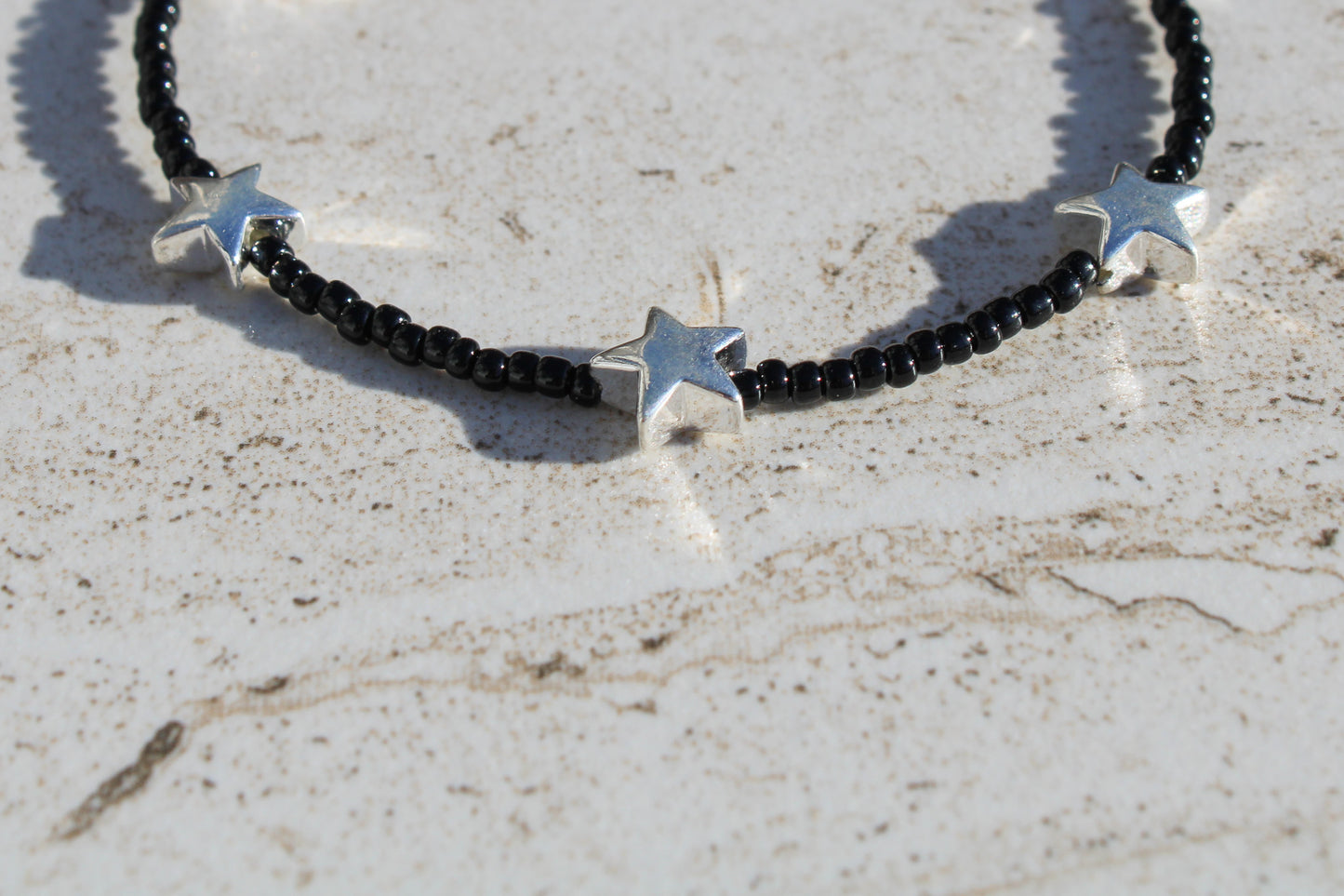 Black Beaded Bracelet with Silver Star Charms