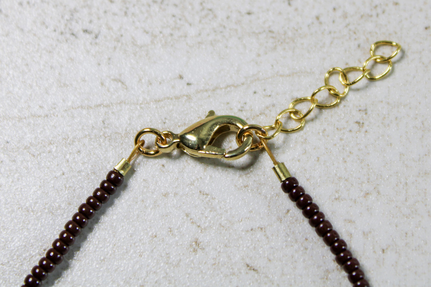 Lobster clasp attached to the end of extender for full fastening display.
