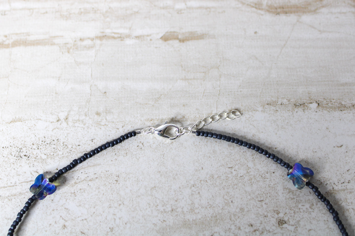 A detailed shot showing both the lobster clasp and extender chain together, showcasing the adjustable length of the necklace.