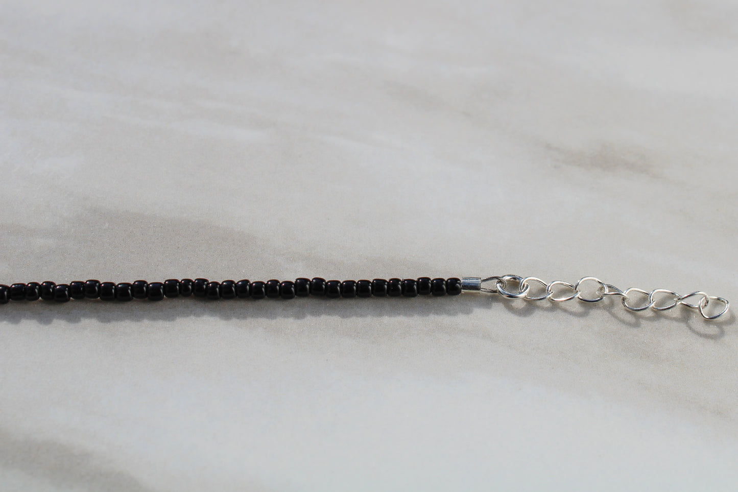 Black and White Beaded Necklace with Tiny Charm