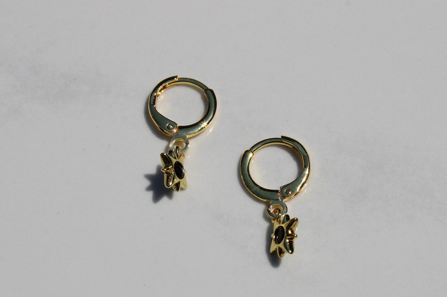 North Star Charm Huggie Hoop Earrings in Black and Gold