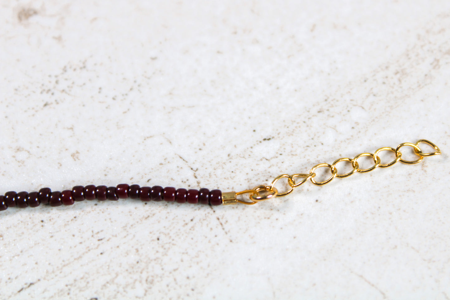 A close up of the gold 1 inch extender chain.