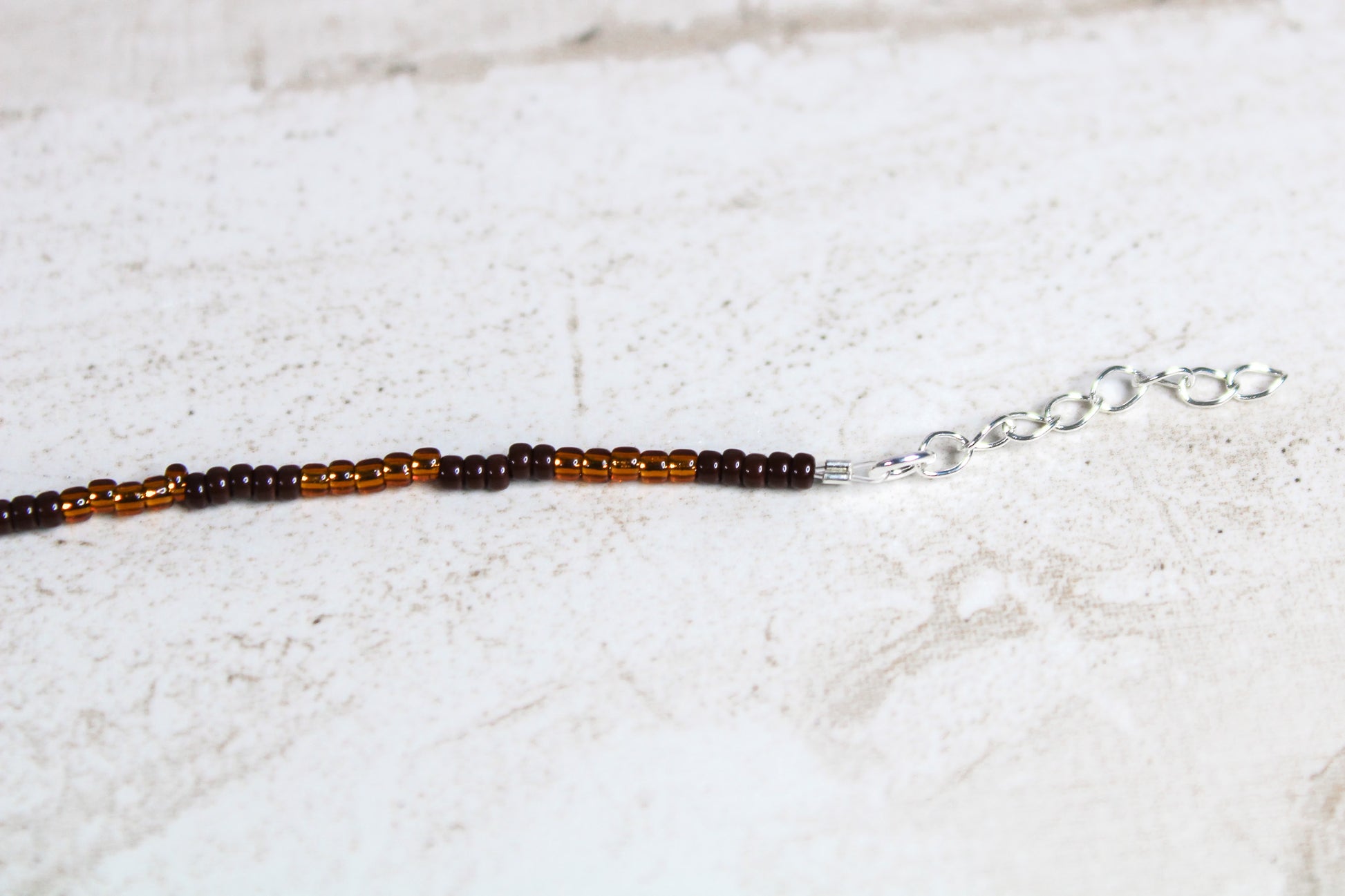 Silver extender chain with multiple links for adjustable sizing.
